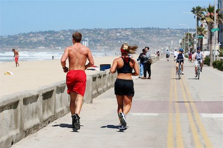 Couple running along the beach Stock Photo - Budget Royalty-Free & Subscription, Code: 400-03944616