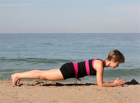 simsearch:640-03260345,k - Woman doing yoga exercise on the beach Photographie de stock - Aubaine LD & Abonnement, Code: 400-03944627