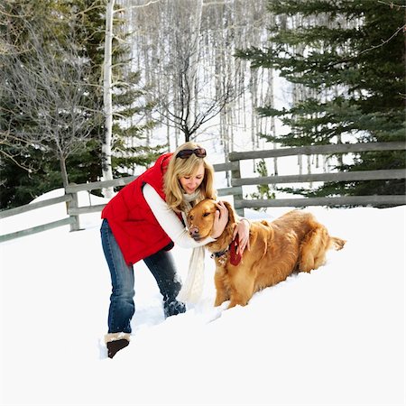 simsearch:400-03944669,k - Woman with arms around dog in snow covered Colorado landscape. Photographie de stock - Aubaine LD & Abonnement, Code: 400-03944673