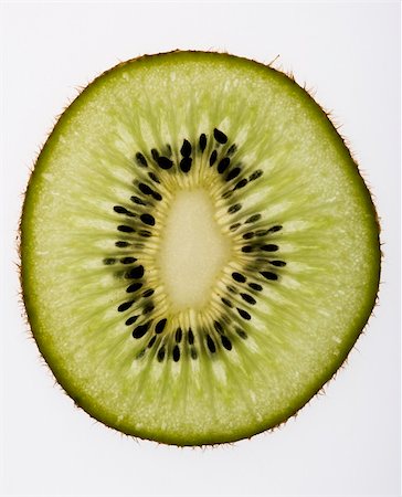 simsearch:6118-07440570,k - Close up of single kiwi fruit slice on white background. Photographie de stock - Aubaine LD & Abonnement, Code: 400-03944682