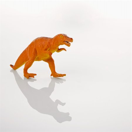 Plastic toy Tyrannosaurus dinosaur. Fotografie stock - Microstock e Abbonamento, Codice: 400-03944786