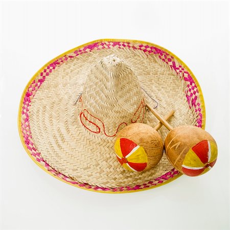 Pair of handmade Mexican maracas percussion musical instruments on sombrero straw hat. Stock Photo - Budget Royalty-Free & Subscription, Code: 400-03944819