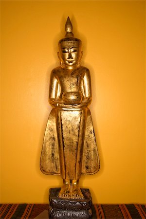 simsearch:400-03944899,k - Golden wooden Buddha statue from Myanmar against yellow wall. Stock Photo - Budget Royalty-Free & Subscription, Code: 400-03944895