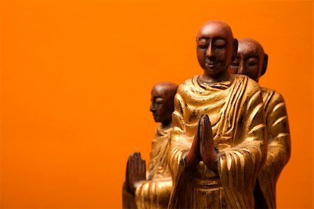 simsearch:400-03944899,k - Three wooden statues of Buddhist disciples against orange wall. Stock Photo - Budget Royalty-Free & Subscription, Code: 400-03944901
