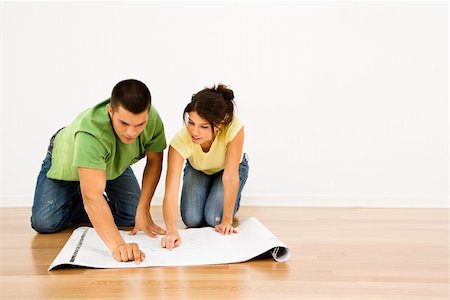 simsearch:673-02141754,k - Attractive young adult couple looking at house plans. Stock Photo - Budget Royalty-Free & Subscription, Code: 400-03944921