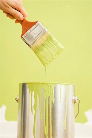 Caucasian female hand holding paintbrush over paint can. Stock Photo - Budget Royalty-Free & Subscription, Code: 400-03944978