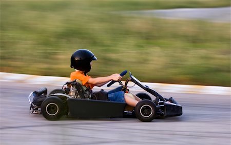 simsearch:400-04482743,k - Panning shot of  a young man carting at fast speed Stock Photo - Budget Royalty-Free & Subscription, Code: 400-03944970
