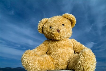 Teddy bear agaist blue sky with cirrus clouds Stock Photo - Budget Royalty-Free & Subscription, Code: 400-03945177