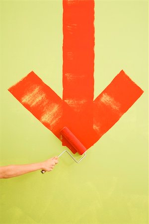 simsearch:614-01270034,k - Caucasian female hand painting red downwards arrow on wall. Stockbilder - Microstock & Abonnement, Bildnummer: 400-03945353