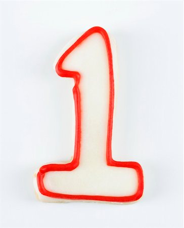 Sugar cookie in the shape of a number one outlined in red icing. Photographie de stock - Aubaine LD & Abonnement, Code: 400-03945361