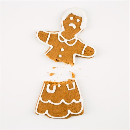 Frowning female gingerbread cookie broken in half. Stock Photo - Budget Royalty-Free & Subscription, Code: 400-03945377