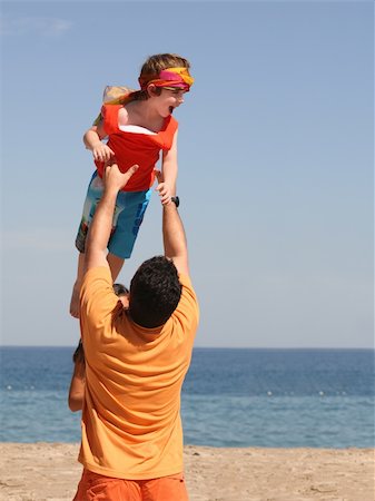 Father playing with his son on the beach Stock Photo - Budget Royalty-Free & Subscription, Code: 400-03945542
