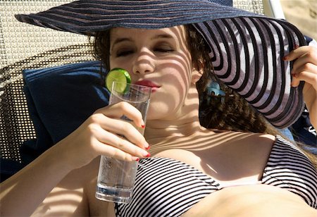 Gorgeous teen girl drinking water on the beach Stock Photo - Budget Royalty-Free & Subscription, Code: 400-03945576