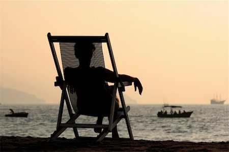 simsearch:400-08495448,k - Woman sitting in the chair watching sunset at the beach Stock Photo - Budget Royalty-Free & Subscription, Code: 400-03945590