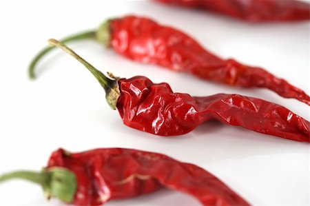 poivre de cayenne - Spicy red chili peppers on a white background Photographie de stock - Aubaine LD & Abonnement, Code: 400-03945854