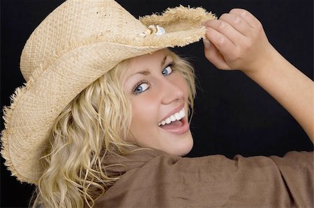 simsearch:400-04058311,k - Studio shot of a beautiful young woman with bright blue eyes wearing a straw cowboy hat and laughing Foto de stock - Super Valor sin royalties y Suscripción, Código: 400-03946148