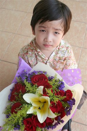 sorry boy pictures - Little boy holding bouquet of red roses and lily Stock Photo - Budget Royalty-Free & Subscription, Code: 400-03947220