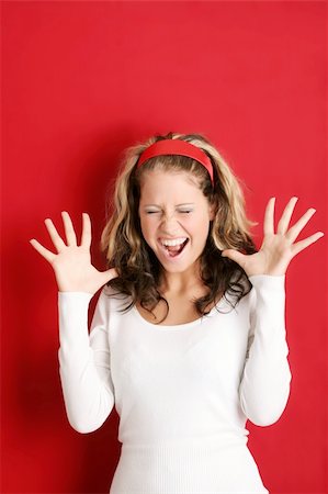 sad and happy school students - A young, attractive and happy woman is screaming Stock Photo - Budget Royalty-Free & Subscription, Code: 400-03947240