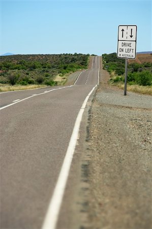 simsearch:862-03736292,k - A road sign in the outback that warns, Drive on left in Australia.  Focus is on the sign - landscape is slightly out of focus. Foto de stock - Super Valor sin royalties y Suscripción, Código: 400-03947419