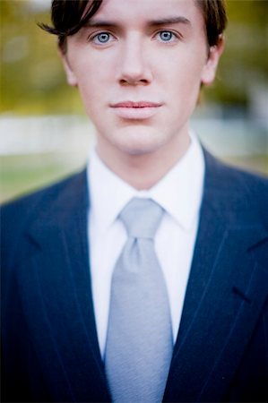 single businessman standing - close-up view of single businessman wearing blue suit and gray tie with brown hair and blue eyes Photographie de stock - Aubaine LD & Abonnement, Code: 400-03947826