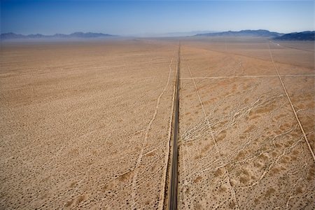 simsearch:400-04169658,k - Aerial view of two lane highway in desert with mountains in background. Stock Photo - Budget Royalty-Free & Subscription, Code: 400-03948664