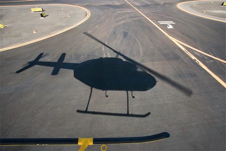 simsearch:614-02763468,k - Aerial of helicopter shadow on airport runway pavement. Stockbilder - Microstock & Abonnement, Bildnummer: 400-03948693