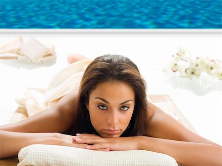 simsearch:400-04359883,k - portrait of a beautiful brunette laying down on a wood carpet near a swiming pool Stock Photo - Budget Royalty-Free & Subscription, Code: 400-03948978