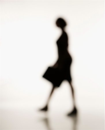 Soft focus silhouette of walking businesswoman holding briefcase. Stock Photo - Budget Royalty-Free & Subscription, Code: 400-03949165