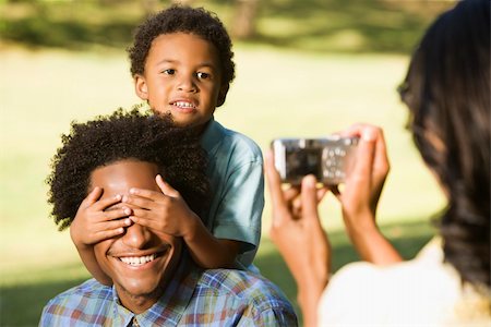 Woman photographing husband and son in park with digital camera. Photographie de stock - Aubaine LD & Abonnement, Code: 400-03949283