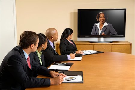 Businesspeople sitting at conference table looking at flat screen display. Stock Photo - Budget Royalty-Free & Subscription, Code: 400-03949343