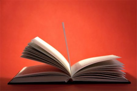 simsearch:700-00605328,k - Open book with pages on red background Fotografie stock - Microstock e Abbonamento, Codice: 400-03949445