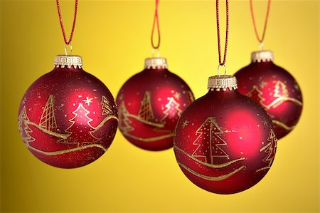 round ornament hanging of a tree - Christmas baubles hanging over yellow background Stock Photo - Budget Royalty-Free & Subscription, Code: 400-03949618