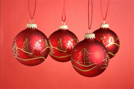 round ornament hanging of a tree - Christmas baubles hanging over red background Stock Photo - Budget Royalty-Free & Subscription, Code: 400-03949620