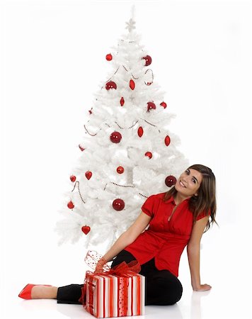 simsearch:649-07436587,k - Beautiful happy woman near a white Christmas tree holding Christmas presents Fotografie stock - Microstock e Abbonamento, Codice: 400-03949704