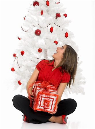 simsearch:649-07436587,k - Beautiful happy woman near a white Christmas tree holding Christmas presents Fotografie stock - Microstock e Abbonamento, Codice: 400-03949703