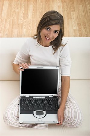 simsearch:400-04017977,k - Beautiful woman working at home with her laptop and showing something to you Photographie de stock - Aubaine LD & Abonnement, Code: 400-03949729