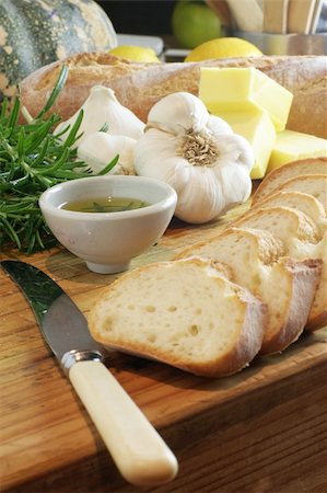 Preparation for making garlic bread. A series of pics in landscape and portrait format. Shallow and deep depth of field. Stock Photo - Budget Royalty-Free & Subscription, Code: 400-03940008