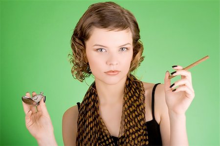 simsearch:400-03965656,k - a glamorous girl in the evening dress holding the watch and a cigarette Photographie de stock - Aubaine LD & Abonnement, Code: 400-03940158