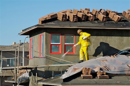 rain on roof - Construction worker pressure washes fresh applied surface of new home exterior. Stock Photo - Budget Royalty-Free & Subscription, Code: 400-03940286