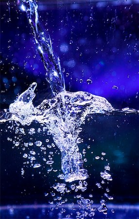 water splash in transparent glass over blue background Stock Photo - Budget Royalty-Free & Subscription, Code: 400-03940329