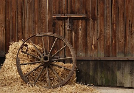 the old antique wheel from cart on background of hay and barn Stock Photo - Budget Royalty-Free & Subscription, Code: 400-03940412