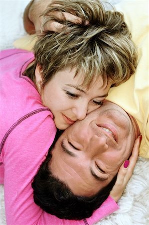simsearch:400-04665936,k - Sweet young couple lying on the rug Stock Photo - Budget Royalty-Free & Subscription, Code: 400-03940448