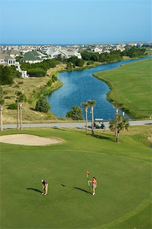 simsearch:400-04468744,k - Aerial view of two people palying golf near residential community at Bald Head Island, North Carolina. Stock Photo - Budget Royalty-Free & Subscription, Code: 400-03940595