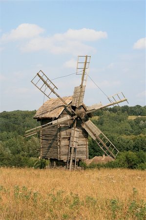 simsearch:400-06101286,k - Old wooden windmill with field and forest on the background Stock Photo - Budget Royalty-Free & Subscription, Code: 400-03940657