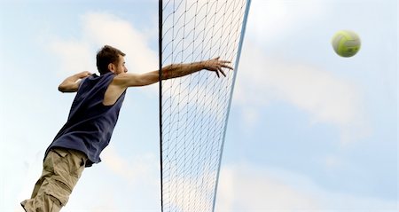 simsearch:400-04461812,k - Young man hitting the ball over the net Stock Photo - Budget Royalty-Free & Subscription, Code: 400-03940677