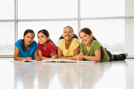 simsearch:400-03923096,k - Preteen girls of mutiple ethnicities sitting together on floor with schoolwork smiling at viewer. Stock Photo - Budget Royalty-Free & Subscription, Code: 400-03940760