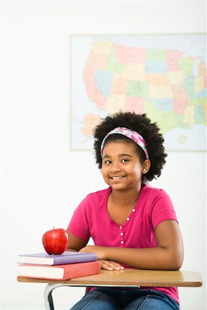 simsearch:400-03923096,k - African American girl sitting in school desk smiling at viewer. Stock Photo - Budget Royalty-Free & Subscription, Code: 400-03940957