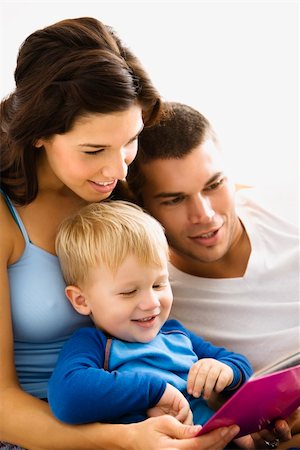 Caucasian parents and toddler son reading book together. Stock Photo - Budget Royalty-Free & Subscription, Code: 400-03941018