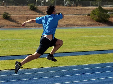 simsearch:6109-08928446,k - Man running on a blue racetrack Photographie de stock - Aubaine LD & Abonnement, Code: 400-03941404