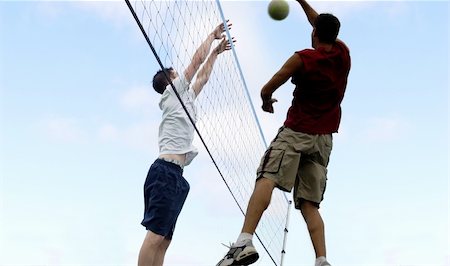 simsearch:400-04461812,k - Young man hitting the ball over the net Stock Photo - Budget Royalty-Free & Subscription, Code: 400-03941402